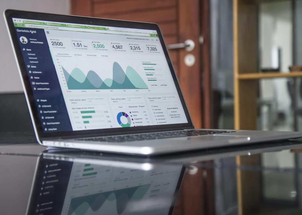 Laptop showing marketing analytics charts on a desk