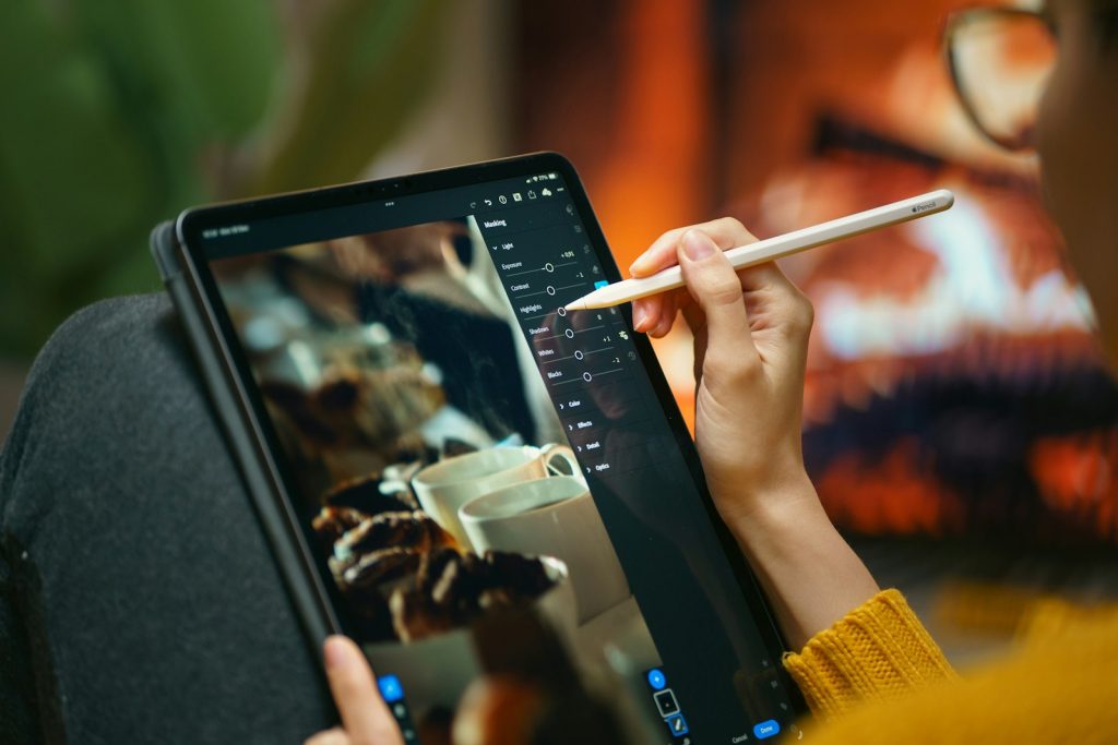 Designer editing graphics on a tablet with a digital pen