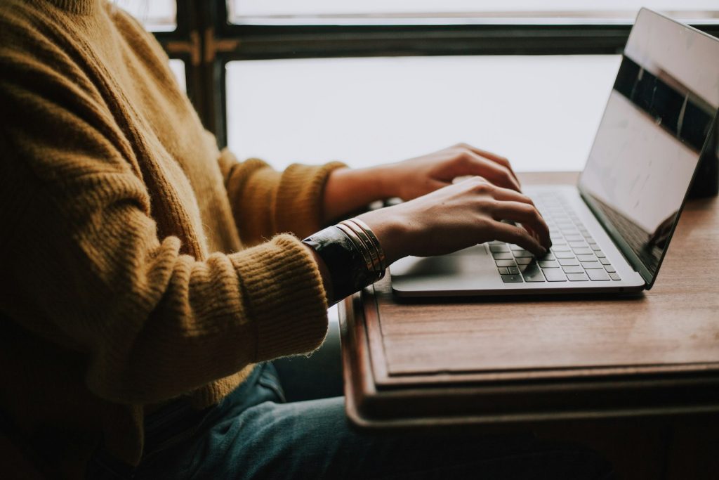 Writer working on a laptop at a table