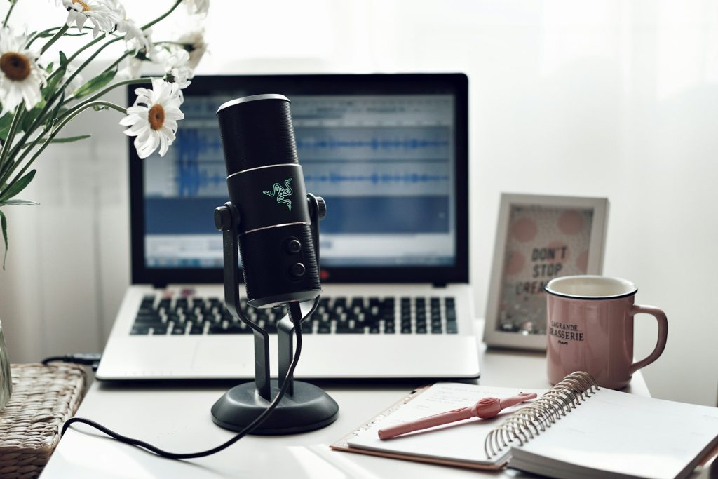 Microphone set up beside a laptop for voice-over recording