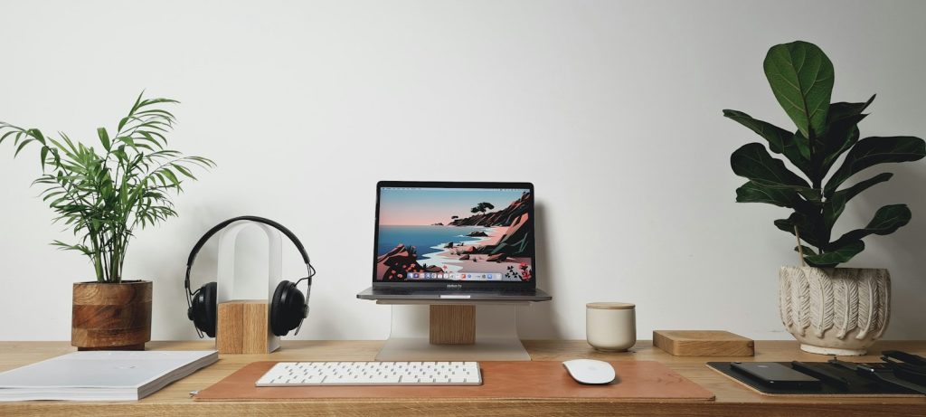 Tidy home office desk with a computer and headphones