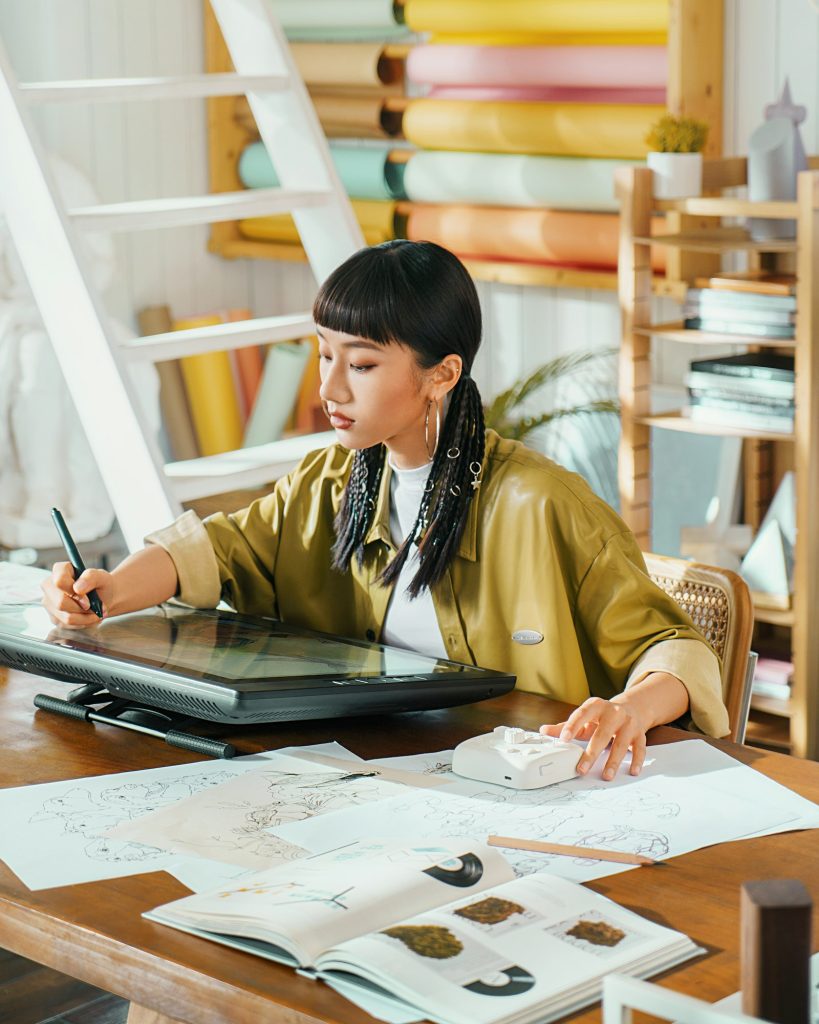 Designer drawing on a digital tablet in a studio