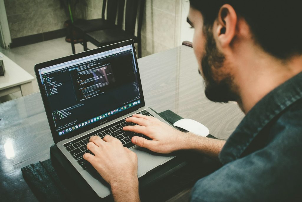 Developer writing code on a laptop