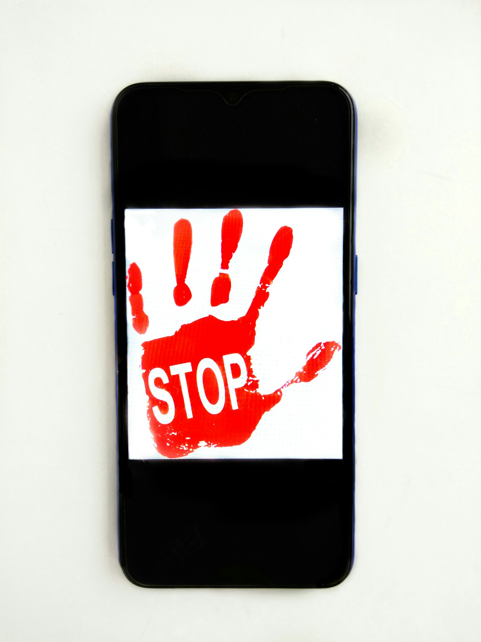 Smartphone screen showing a red STOP hand warning sign