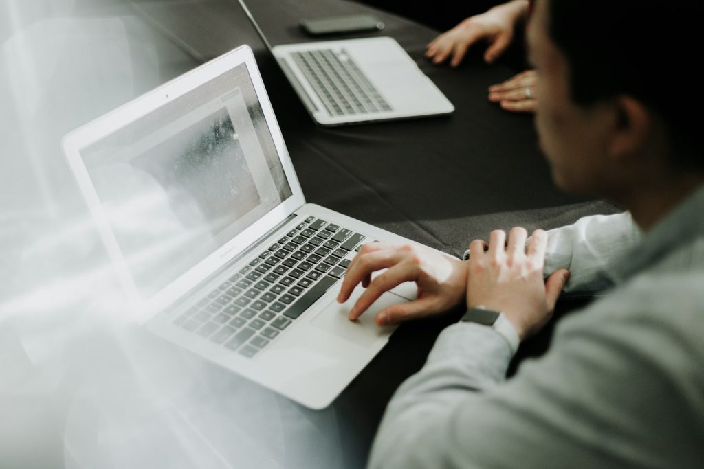 Person typing instructions on a laptop