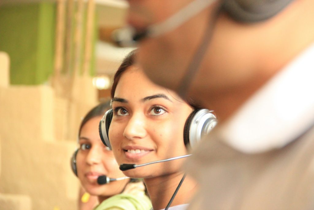 Customer support agents wearing headsets at work