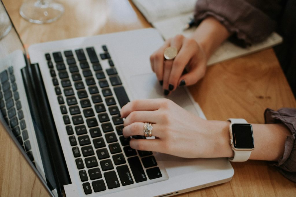Writer typing a blog post on a laptop